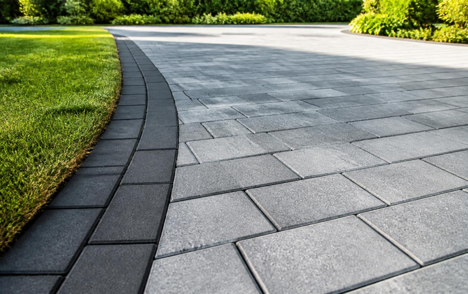 Newly installed premium block paved driveway outside a modern UK home at dusk